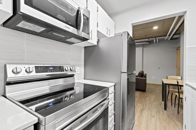 Stainless steel stove microwave cabinets and refrigerator kitchen at Auraria Student Loft in Denver Student Accommodation