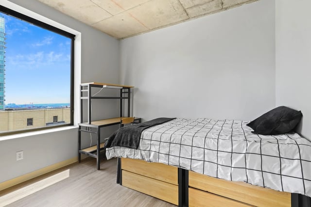 Bed desk and window bedroom at Auraria Student Loft in Denver Student Accommodation