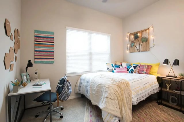 Bed desk chair artwork pillows lamps bedroom at Gateway on Cullen in Houston Student Accommodation
