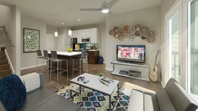 Living room with kitchen island TV and sofa. at Gateway on Cullen in Houston Student Accommodation