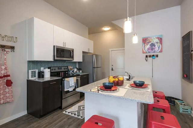 Modern kitchen with stainless steel appliances and island kitchen at Gateway on Cullen in Houston Student Accommodation