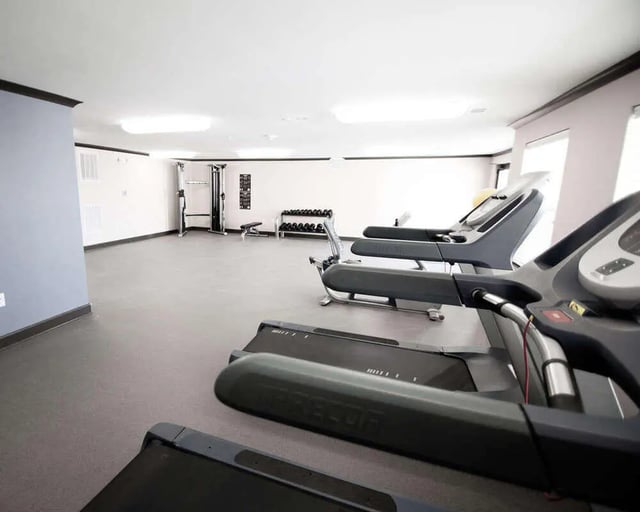 Treadmills dumbbells weight rack gym. at Goodnight Commons in Austin Student Accommodation
