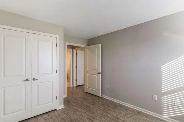 Two white doors open to hallway bedroom at Goodnight Commons in Austin Student Accommodation