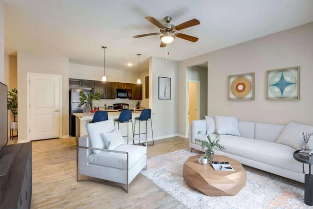 Sofa white armchair coffee table living room at Goodnight Commons in Austin Student Accommodation