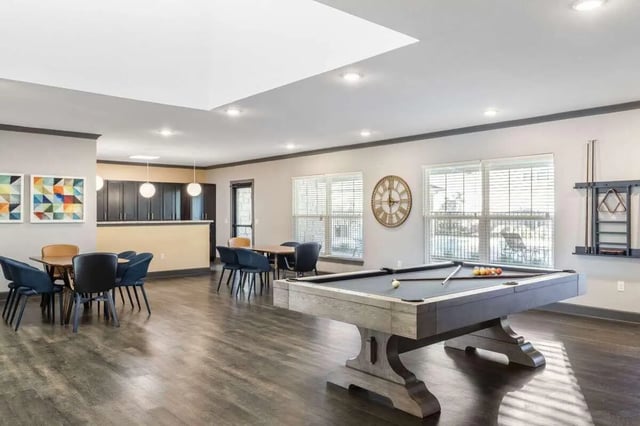 Pool table dining tables and kitchen area game room at Goodnight Commons in Austin Student Accommodation