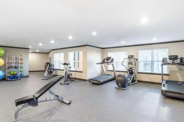 Gym equipment weights bench treadmills gym area at Goodnight Commons in Austin Student Accommodation