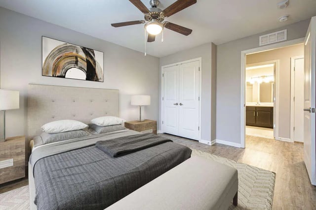 Bed with artwork and ceiling fan bedroom at Goodnight Commons in Austin Student Accommodation