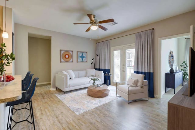 White couch rug coffee table chairs living room at Goodnight Commons in Austin Student Accommodation