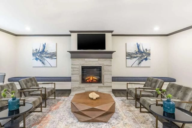 Chairs fireplace and coffee table living room at Goodnight Commons in Austin Student Accommodation