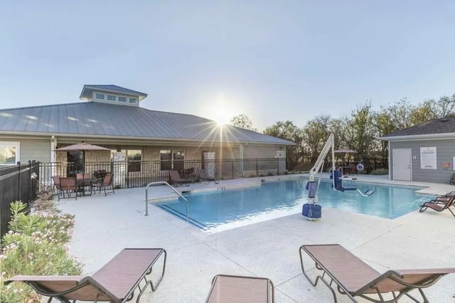 Pool with lounge chairs and lift exterior at Goodnight Commons in Austin Student Accommodation
