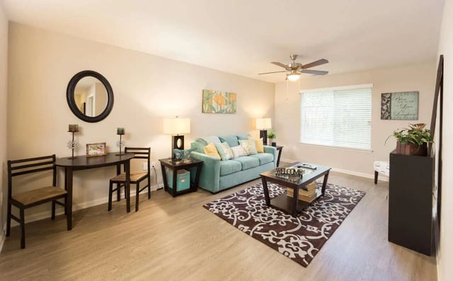 Aqua sofa coffee table rug living room at Harris Branch Senior in Austin Student Accommodation