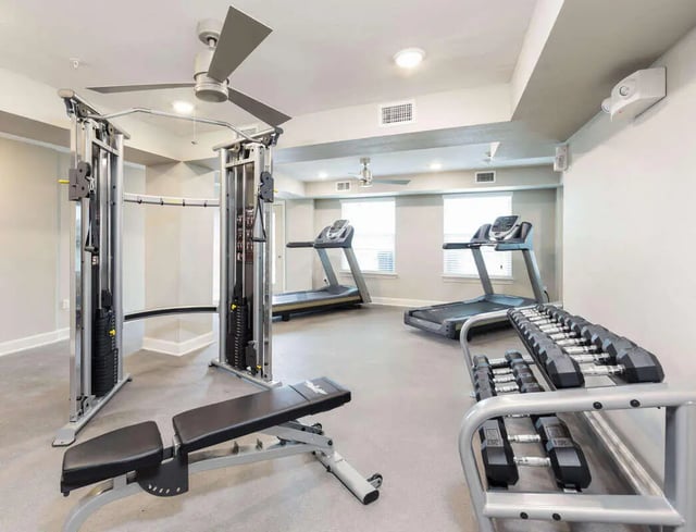 Cable machine treadmill bench and dumbbells gym area at Harris Branch Senior in Austin Student Accommodation