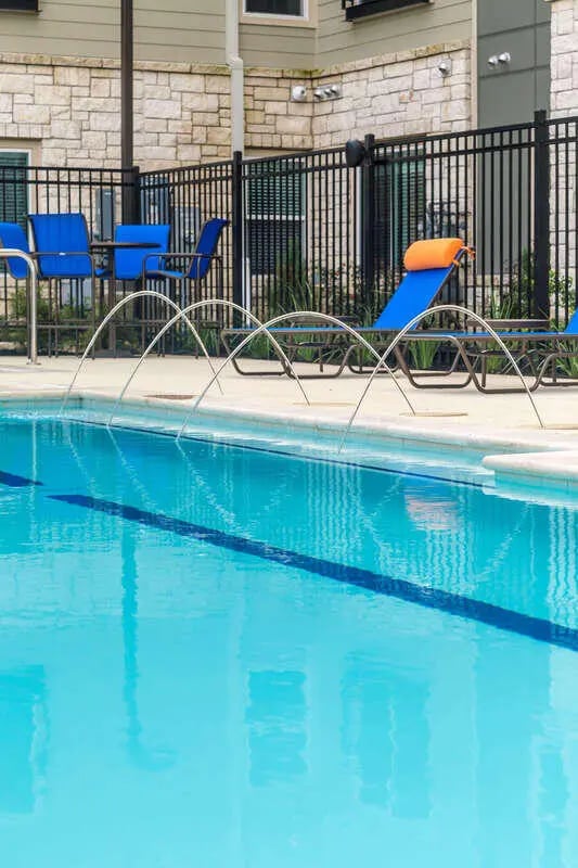 Blue chairs tables lounge chairs exterior at Harris Branch Senior in Austin Student Accommodation