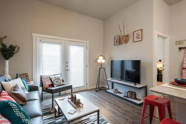 Sofa coffee table tv and floor lamp living room at Gateway on Cullen in Houston Student Accommodation