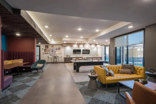 Banquette seating yellow sofa ping pong table living room at Gateway on Cullen in Houston Student Accommodation