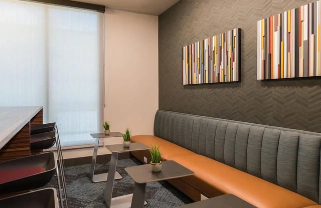 Orange and grey booth with modern art living area at Gateway on Cullen in Houston Student Accommodation