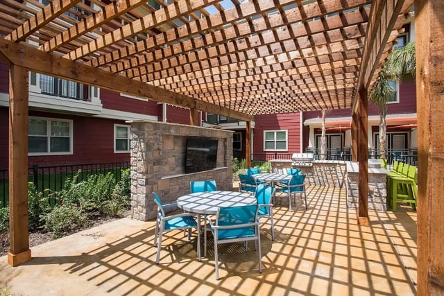Outdoor lounge area with tables chairs and grills patio area at Gateway on Cullen in Houston Student Accommodation