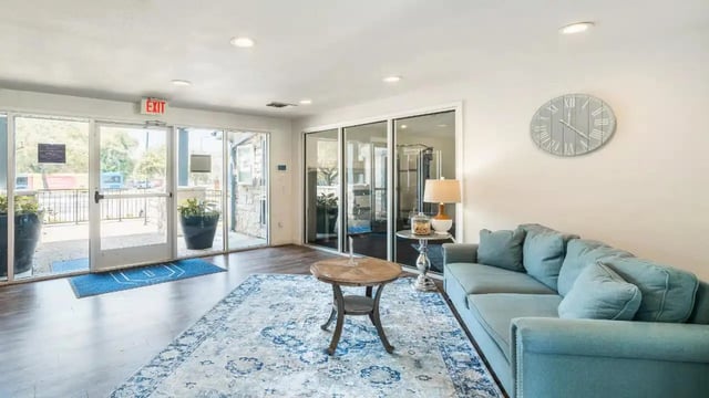 Blue sofa and coffee table living room at Ironhorse Flats in Austin Student Accommodation