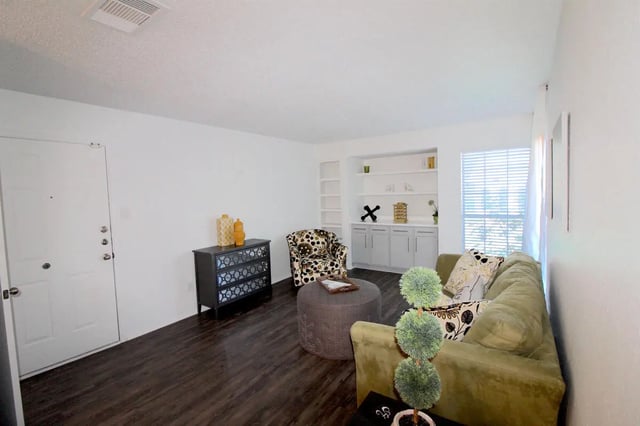 Sofa ottoman patterned chair storage shelves living room at Ironhorse Flats in Austin Student Accommodation