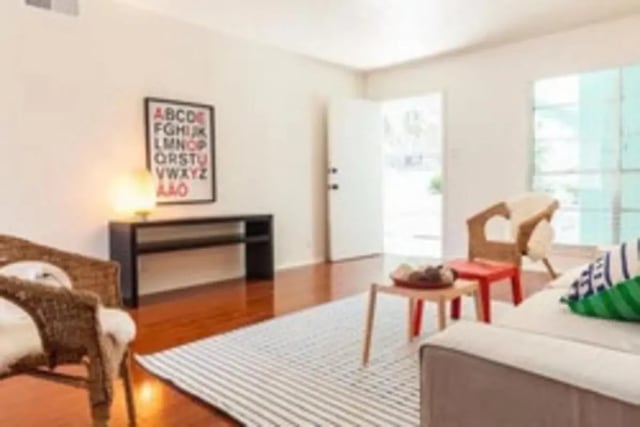 Wicker chairs and alphabet poster living room at Lightsey Place Apartments in Austin Student Accommodation