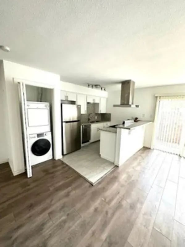 Washer dryer refrigerator and kitchen counter kitchen at Lightsey Place Apartments in Austin Student Accommodation