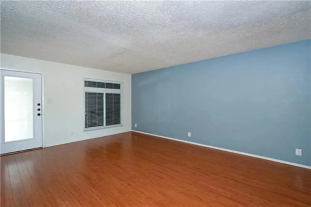 Empty room wood floors white door blue wall living room at Lightsey Place Apartments in Austin Student Accommodation
