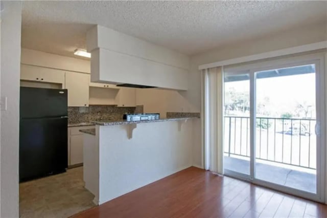 Kitchen with black refrigerator and balcony kitchen at Lightsey Place Apartments in Austin Student Accommodation