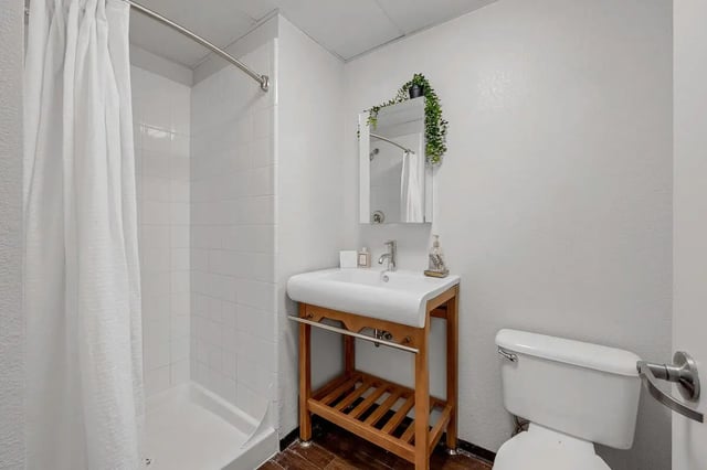 Shower sink and toilet with wood vanity Bathroom at Vista in Denver Student Accommodation