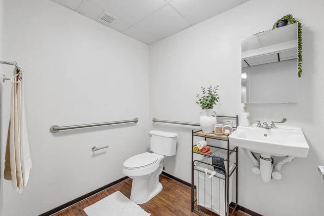 Toilet sink grab bars and towels bathroom at Vista in Denver Student Accommodation