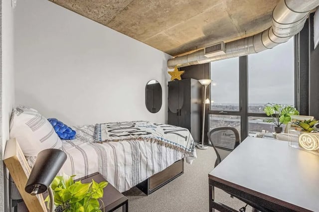 Bed desk plants and wardrobe bedroom at Vista in Denver Student Accommodation