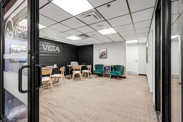 Vista reception area with desk chairs mini-fridge reception area at Vista in Denver Student Accommodation