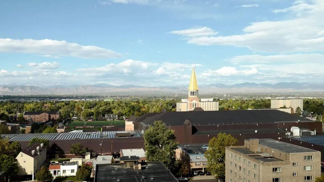 Buildings with green trees and mountains exterior at Vista in Denver Student Accommodation