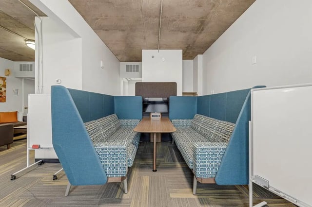 Two booths with sofas and a table lounge at Vista in Denver Student Accommodation