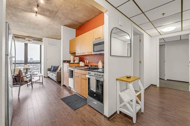 Kitchen and living area with sofa and table kitchen area. at Vista in Denver Student Accommodation