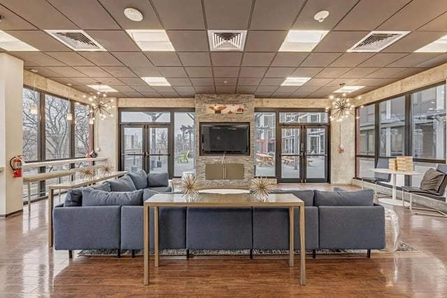 Blue sectional sofa TV and fireplace living room at Vista in Denver Student Accommodation