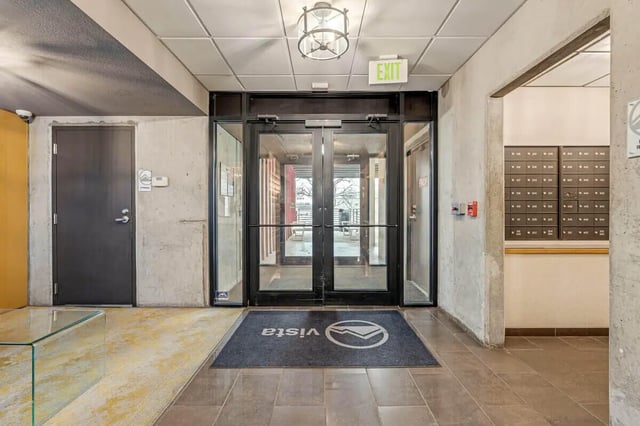 Glass doors mailboxes and black mat entrance area at Vista in Denver Student Accommodation