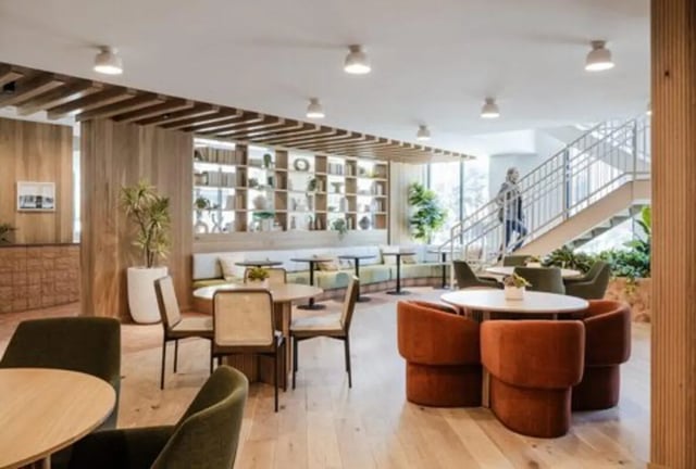 Seating tables and bookshelves common area living room at Rambler Austin in Austin Student Accommodation