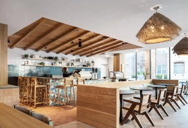 Bar area with stools and seating area common room at Rambler Austin in Austin Student Accommodation