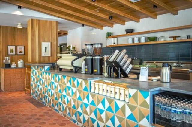 Coffee bar with espresso machine and bottled water cafe at Rambler Austin in Austin Student Accommodation