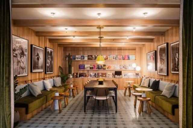 Sofa tables and shelves with books and art Living room at Rambler Austin in Austin Student Accommodation