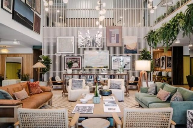 Sofas artwork and plants in communal living space at Rambler Austin in Austin Student Accommodation