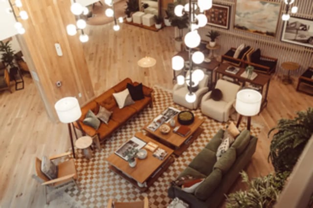 Sofa tables chairs and lighting living room at Rambler Austin in Austin Student Accommodation
