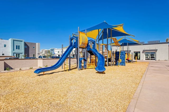 Blue and yellow slides playground equipment playing area at BB Living at Val Vista in Gilbert Student Accommodation
