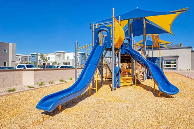 Blue slides yellow structure outdoor playing area at BB Living at Val Vista in Gilbert Student Accommodation