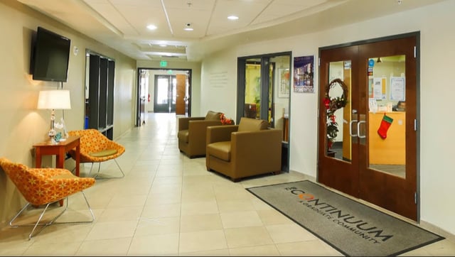 Chairs and television in hallway lounge area. at The Continuum in Gainesville Student Accommodation
