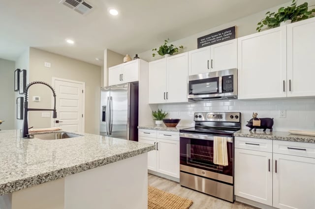 Granite island sink stainless steel appliances white cabinets kitchen at BB Living at Union Park in Phoenix Student Accommodation