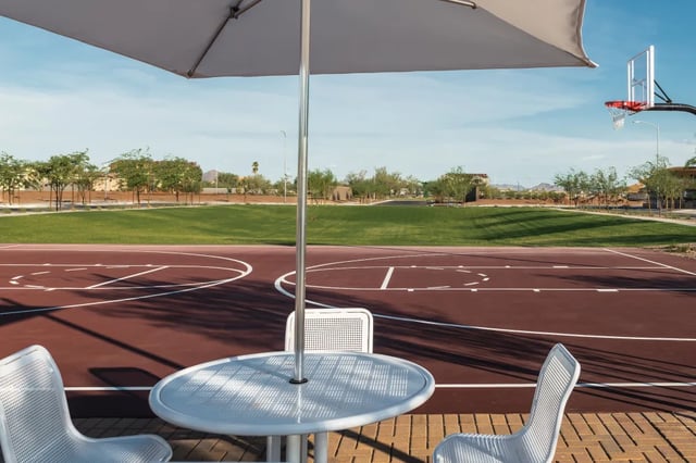 Table umbrella chairs basketball court exterior at BB Living at Union Park in Phoenix Student Accommodation
