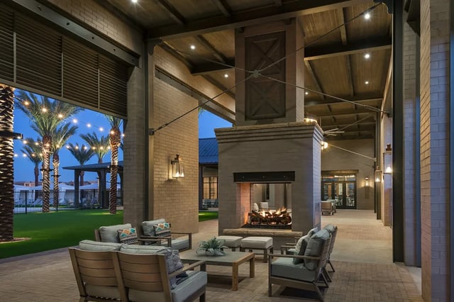 Outdoor seating area with fireplace and palm trees exterior at BB Living at Union Park in Phoenix Student Accommodation
