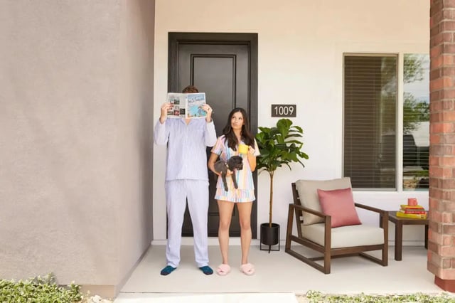Couple with dog by door and outdoor furniture Exterior at BB Living at Civic Square in Goodyear Student Accommodation