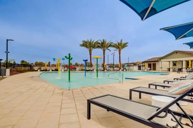 Pool with water features palm trees and lounge chairs exterior at BB Living at Civic Square in Goodyear Student Accommodation